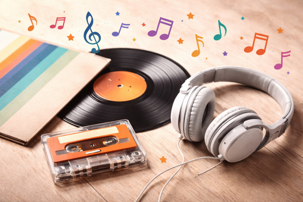 Disco de vinil, fita cassete e fones de ouvido sobre superfície de madeira com notas musicais coloridas ao redor, representando trilhas sonoras nostálgicas.